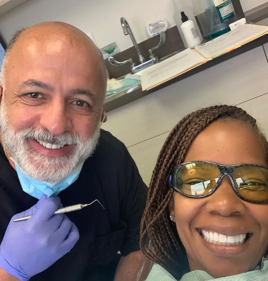 Dr. Bijan Afar and a smiling patient in a treatment room